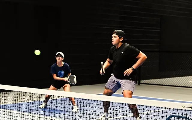 Two players rallying at the net