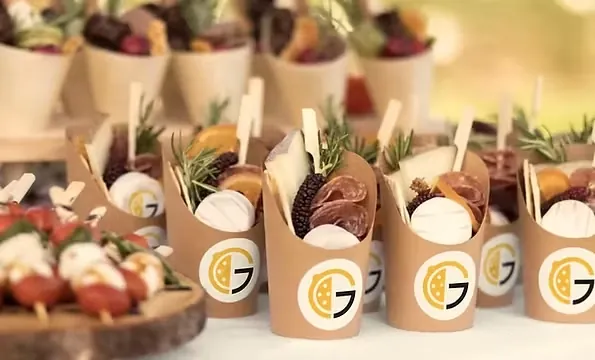 Catered snack cups branded with The Grove logo