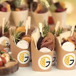 Catered snack cups branded with The Grove logo